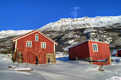 Photo of two boathouses in a winter landscape