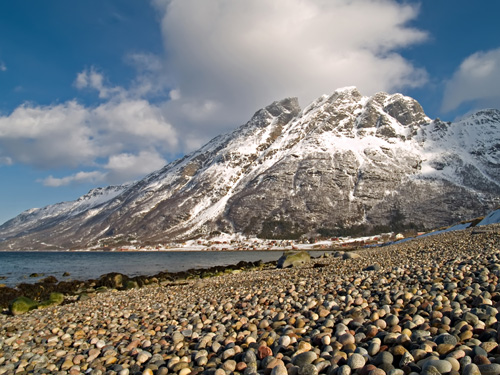 Photo of winter mountain and pebble beach