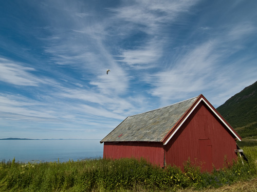 boatshed against a blue summer sky with some beautiful clouds