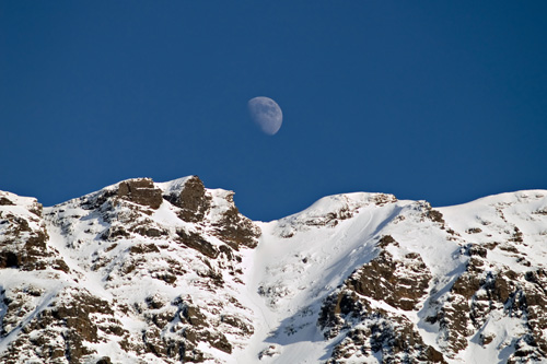 Photo of moon over winter mountain