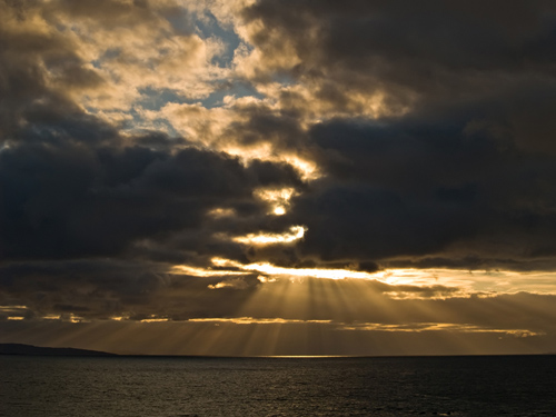 Photo of sunrays over the ocean in northern Norway