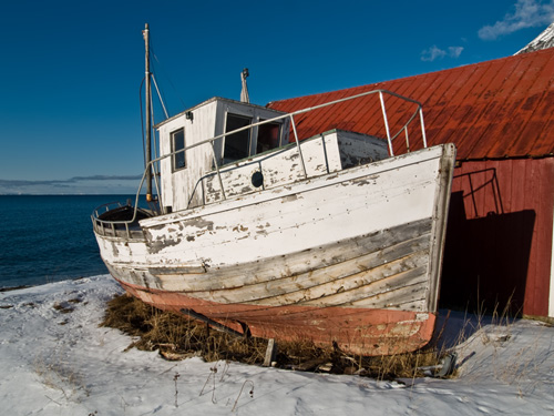 Picture of decaying old Norwegian fishing boat on land