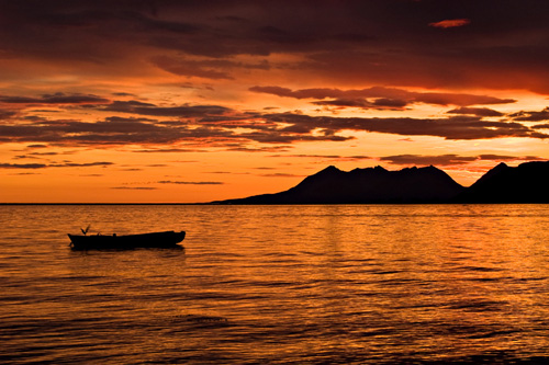 Picture of rowboat and beautiful sunset in northern Norway