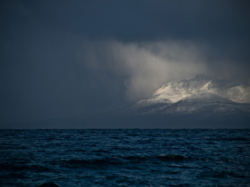 Photo of mountain being illuminated - Blizzard in northern Norway