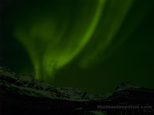Picture of Northern Lights (Aurora Borealis) over snow-clad mountains in Northern Norway