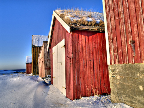 Row of Norwegian boathouses on a winter day