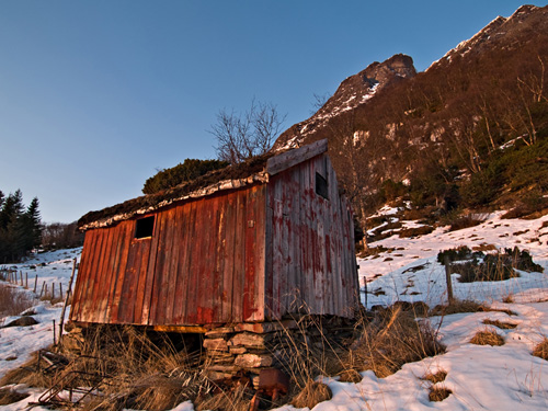 Photo of old Norwegian summer barn against mountain