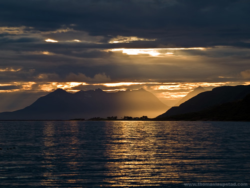 Midnight sunset picture of village in the sea in Northern Norway