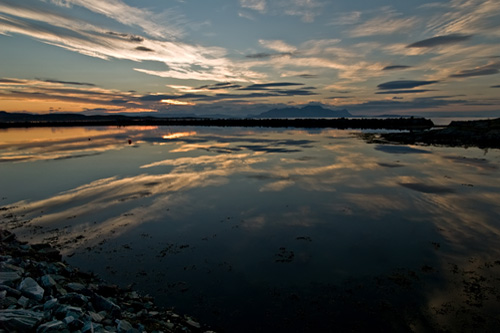 Wide angle picture of Norwegian harbor bathed in sunset